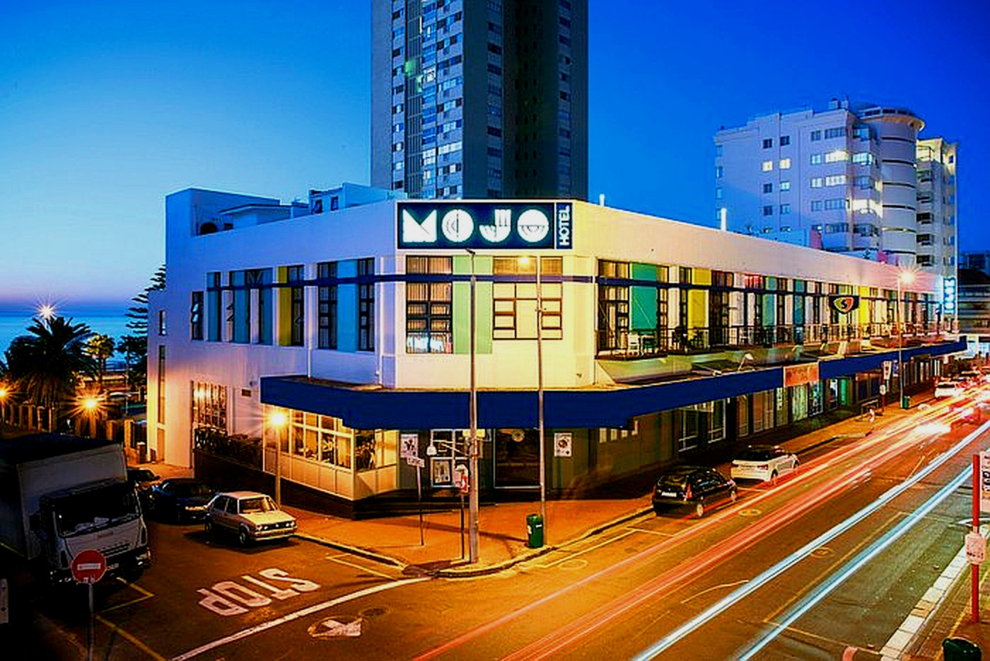 The exterior of The Mojo Hotel in Sea Point at night.