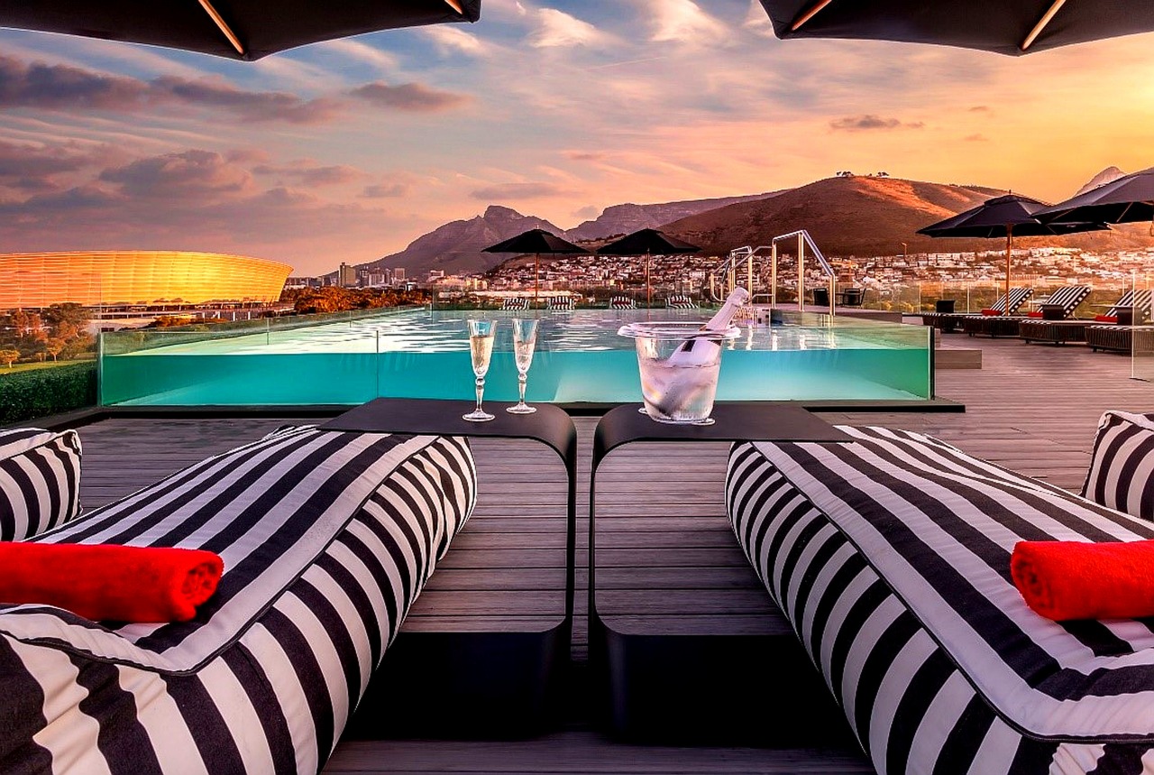 The rooftop pool at the O'Two Hotel at sunset, overlooking Cape Town Stadium and Signal Hill.